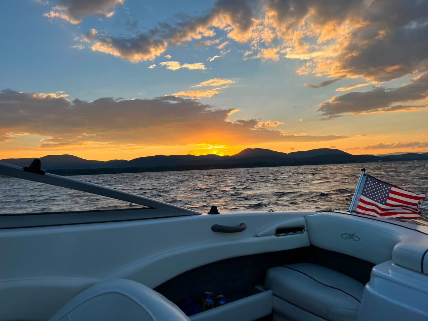 Sunset off the bow, the flag out