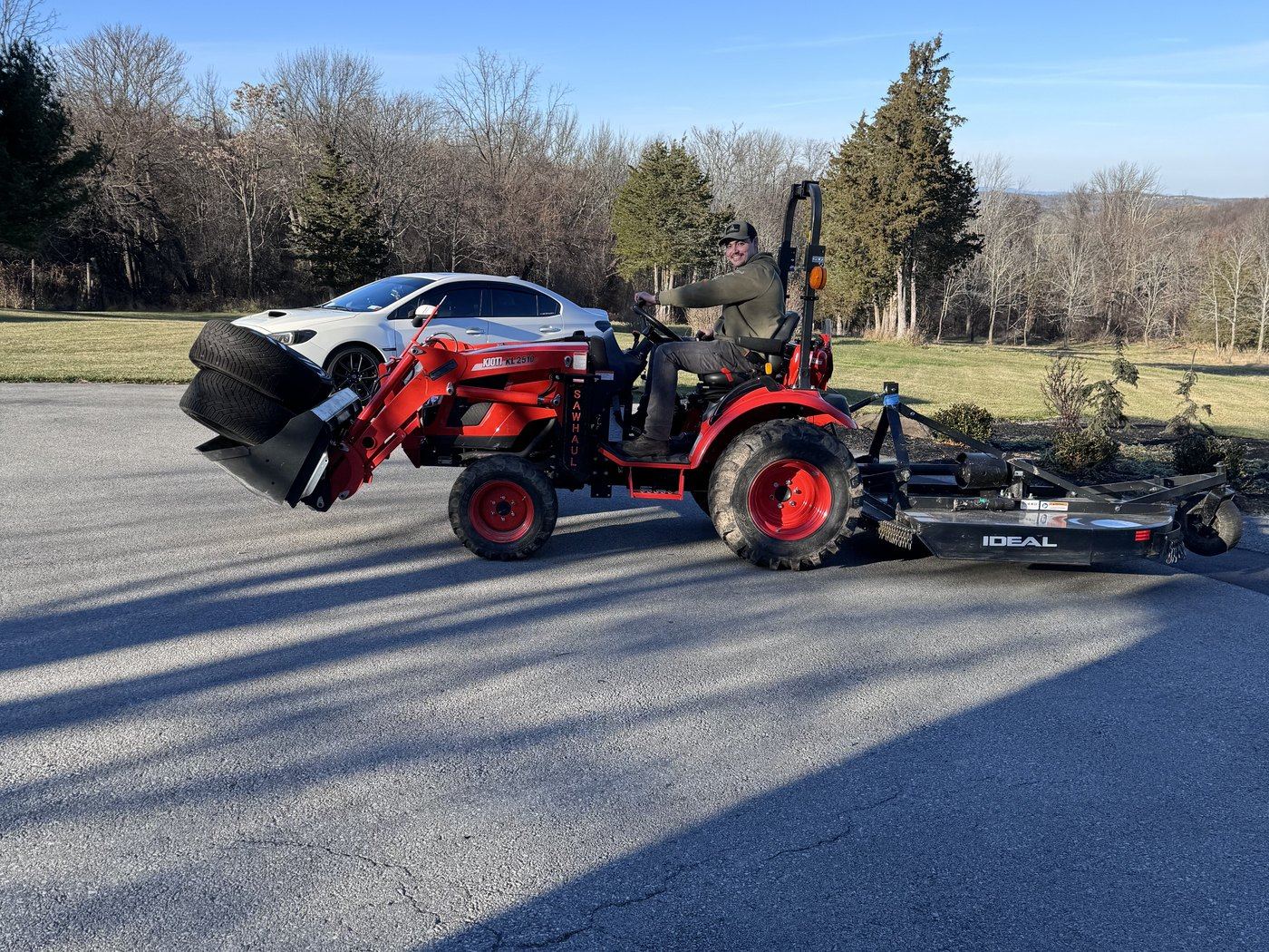 The tractor with the mower on, driveway
